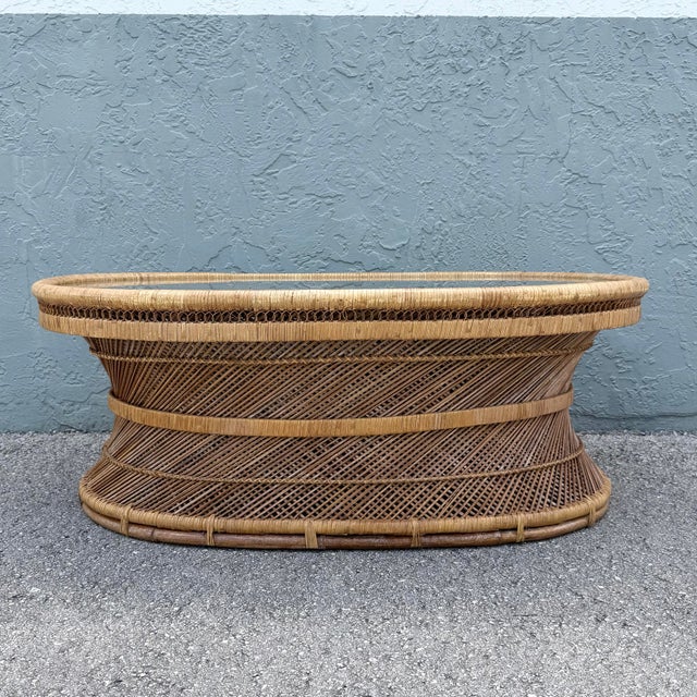 A stunning Boho Chic coffee table handcrafted from buri rattan, showcasing an elegant oval silhouette and exceptional...