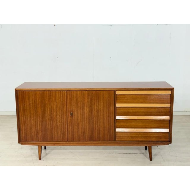 For sale is this beautiful and exceptionally well-preserved mid-century modern sideboard, captivating with its minimalist...