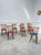 Set of eight vintage Baumann chairs dating from the 1960s with faux leather seats (seven red and one blue). We love their...