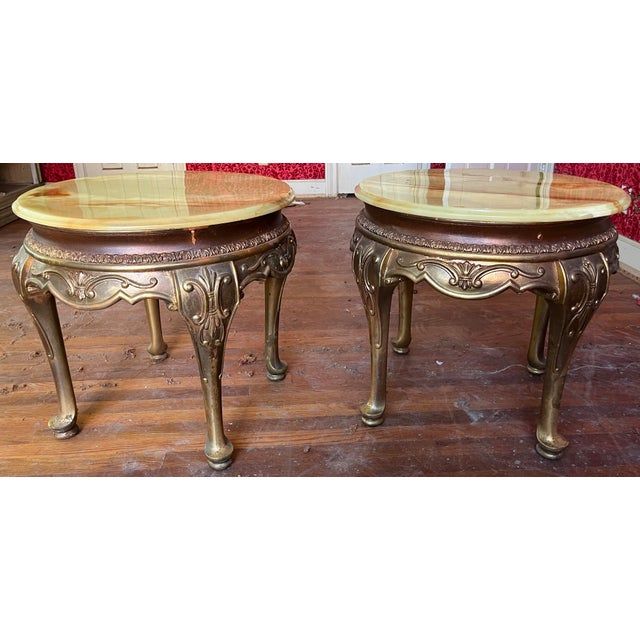Two stunning Hollywood Regency side tables featuring a beautiful onyx tops with warm amber, honey, and rust veining — the...