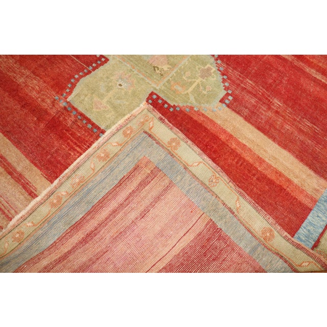 A Primitive early 20th-century Turkish Kars Village Rug with an open field design on a abrashed red ground dated 1906...