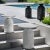 This fossilized stone side table pairs a carved base with a dial-design round top, bringing organic texture beside an...
