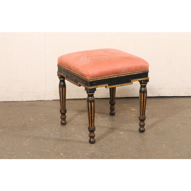 A French painted and parcel-gilt footstool with upholstered seat from the turn of the 18th and 19th century. This antique...