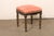 A French painted and parcel-gilt footstool with upholstered seat from the turn of the 18th and 19th century. This antique...