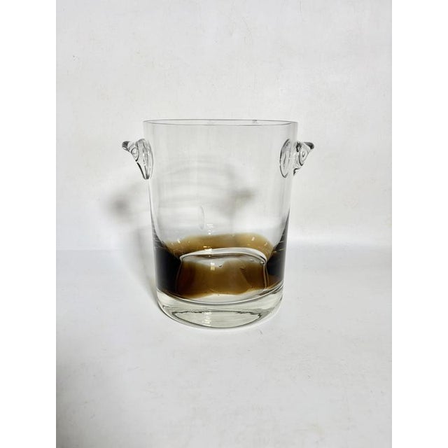 A French ice bucket from the 1970s, crafted from thick, hand-blown glass, with a clean, cylindrical silhouette. It...