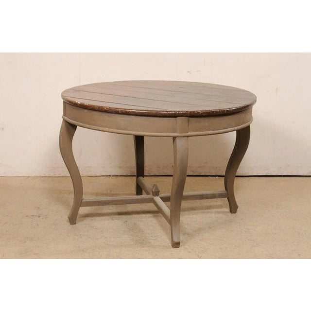 A Brazilian carved and painted peroba wood center table from the 19th century. This antique table from Brazil has a round-...