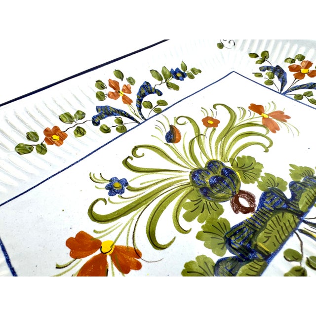 This vintage Italian faience platter features vibrant hand-painted florals in rich olive green, cobalt blue, and warm...