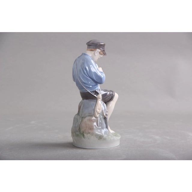 Royal Copenhagen shepherd boy, model No. 905. design Christian Thomsen and execution in blue, brown and green colors with...