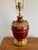 Incredible 1980s Mark Thomas table lamp with ornate brass relief details and painted oxblood red body. A wonderful...