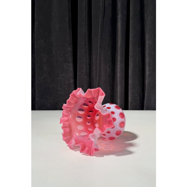 This art glass vase was produced by the Fenton Art Glass Company and features the classic Coin Dot pattern in rich...