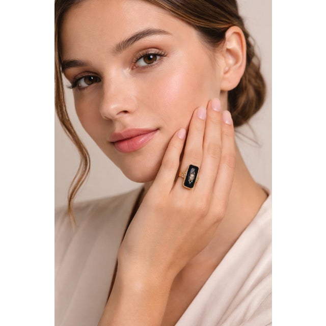 Vintage 10K solid yellow gold ring featuring a sleek black onyx center accented with a single natural diamond set in the...