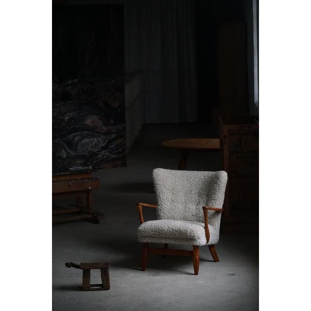 Presenting a charming low back lounge chair from the 1950s, crafted in solid oak and thoughtfully reupholstered in a great...