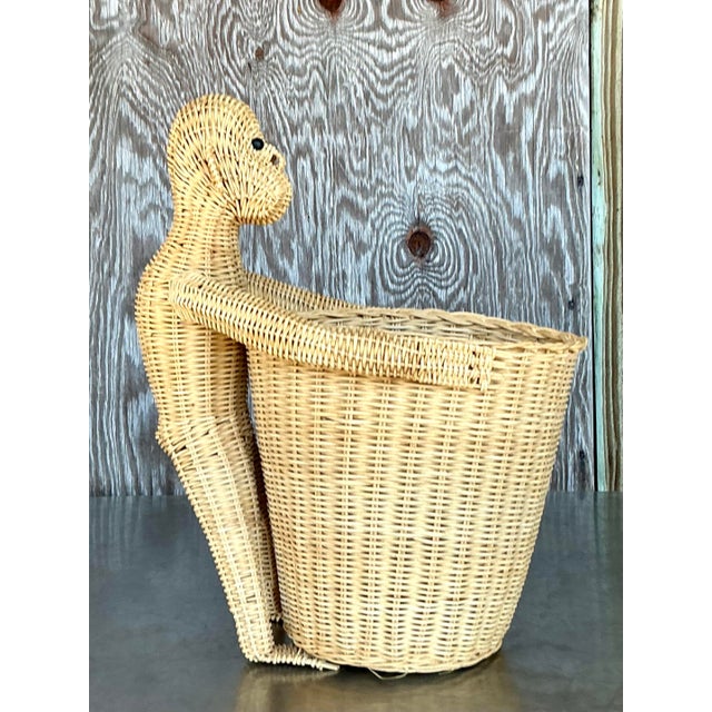 Add a playful touch of coastal charm with this delightful vintage woven rattan monkey waste paper basket! Featuring an...
