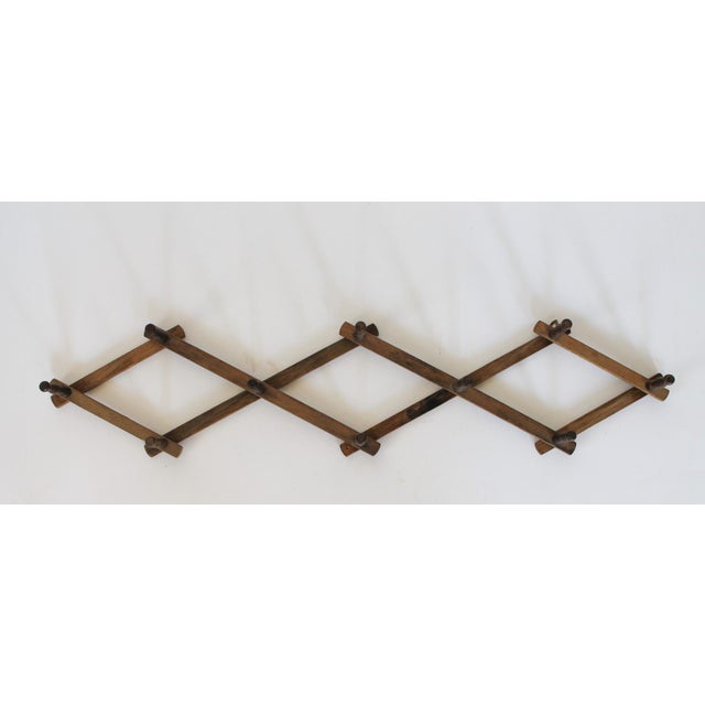 Vintage wood accordion-style hat wall rack. Made in Hong Kong. Some age wear. Ready to hang. Measurements are approximate...