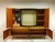 This piece of furniture consists of a base and upper section, combining a display cabinet, bar compartment, and storage...