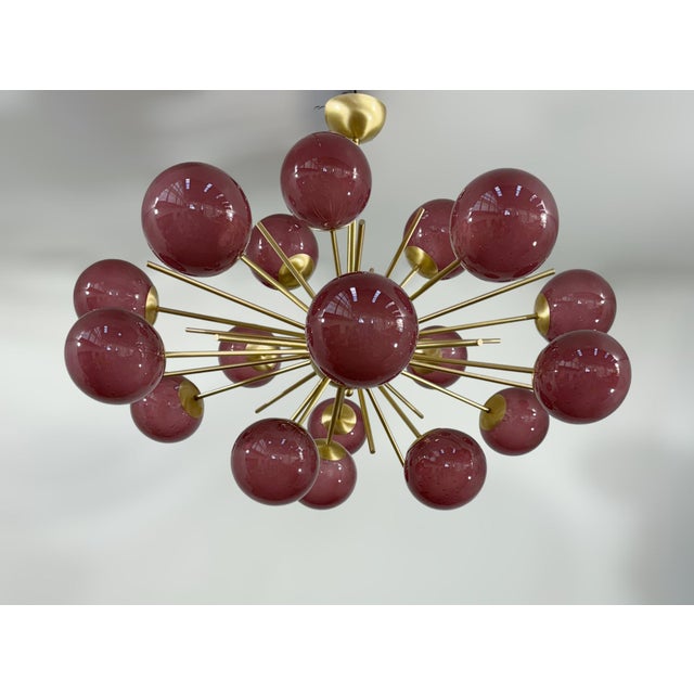 Italian oval shaped sputnik chandelier with 18 frosted amethyst Murano glass globes mounted on brass frame in satin brass...