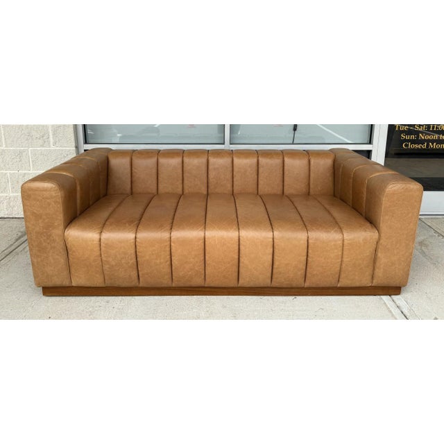 Designed by Mermelada Estudio, the CB2 Forte Sofa features bold channel-tufted saddle leather upholstery wrapped around...