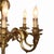 An antique French Louis XIV style 8-light chandelier, crafted from gilt bronze around 1900. This lighting fixture embodies...