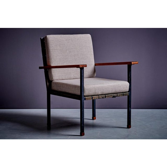 This mid-century armchair, by Carl Auböck, crafted in Vienna around 1955, features a sleek and minimalistic design....