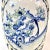 This unique late 20th century porcelain vase is blue, white, and light yellow with decorative blue flowers as handles. On...