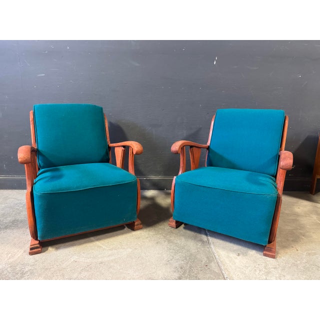 Pair of Vintage Art Deco lounge chairs with carved wood frames and original blue fabric cushions. Dimensions: H 33”x W...
