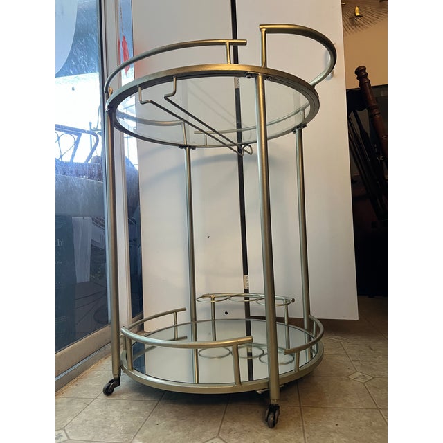 Two Tiers with a glass top shelf and a lower mirrored shelf Integrated hanging stemware racks for wine glasses under the...