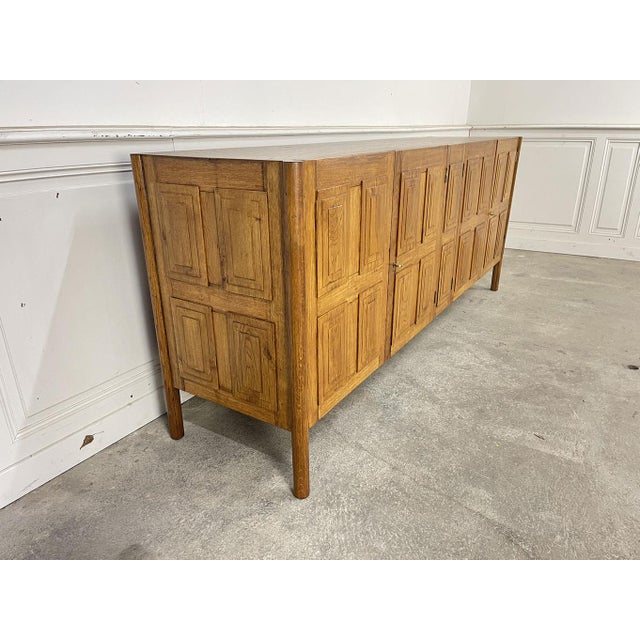 This large sideboard, reminiscent of a credenza, is made of solid oak. In perfect condition, restored and varnished in our...