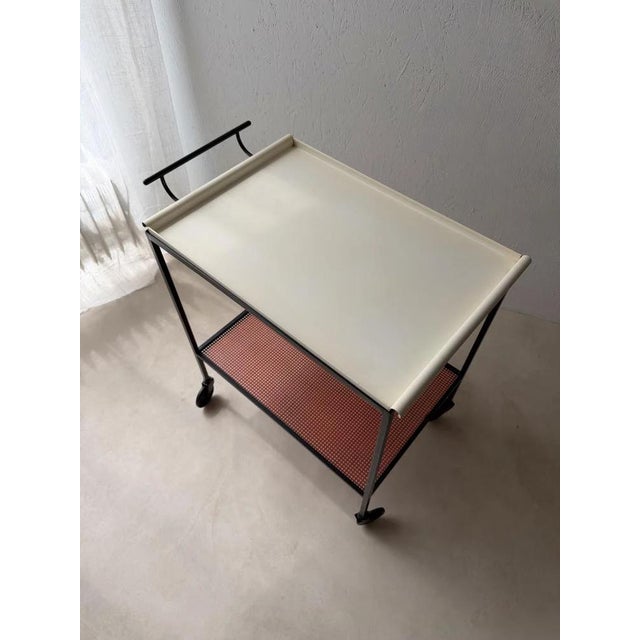 Color sets the rhythm of this original Pilastro serving trolley from the 1960s. Tjerk Reijenga combined a black metal...