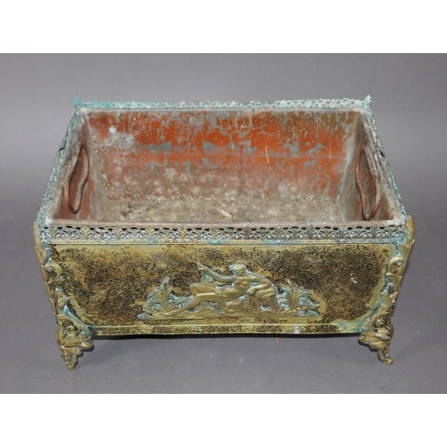 Early 20th century French Jardiniere in bronze with a relief of” Rebecca at the Well” on the front there are lions masks...