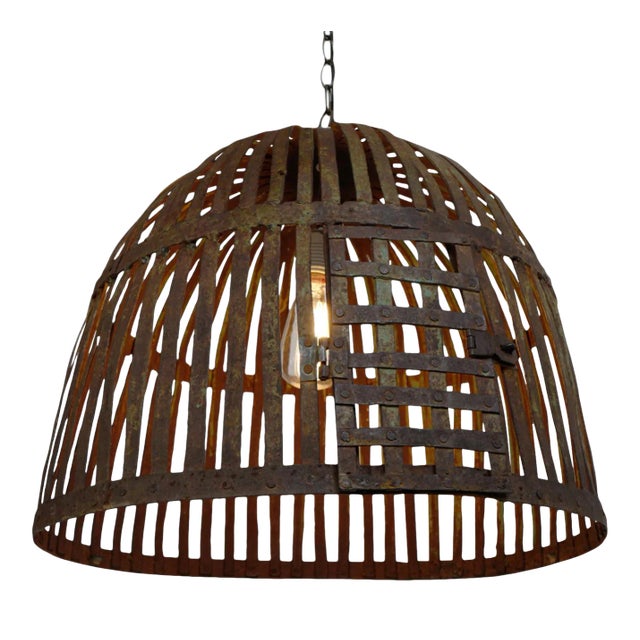Vintage Indian iron cage basket thoughtfully repurposed into a one-of-a-kind pendant light, celebrating the raw beauty of...