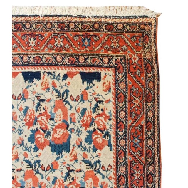 An outstanding late 19th century Persian Senneh rug with an incredible masterfully woven large-scale repeated floral...
