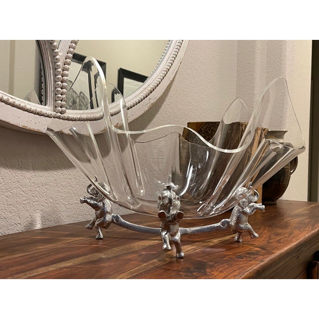 Offering a whimsical Arthur Court serving bowl. This timeless piece is anchored by four standing elephants and topped with...