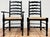 Vintage set of six rich black ladderback chairs with firm rush seats. Set consists of two chairs with arms (measure 23" W...