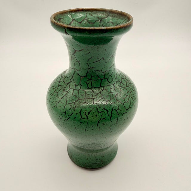 This item is a Chinese-style porcelain vase featuring a vibrant apple-green crackle glaze. Vases of this design feature an...