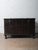 This vintage wooden storage chest from India features impressive iron-bound construction, forged metal strapping, and...