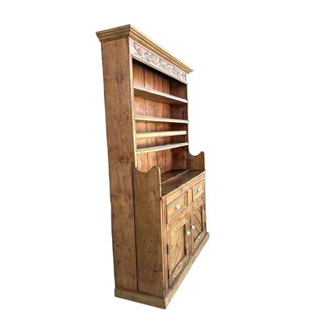 An Antique Pine Welsh Dresser (Hutch). The base with 2 cupboards and 2 drawers fitted with original Victorian porcelain...