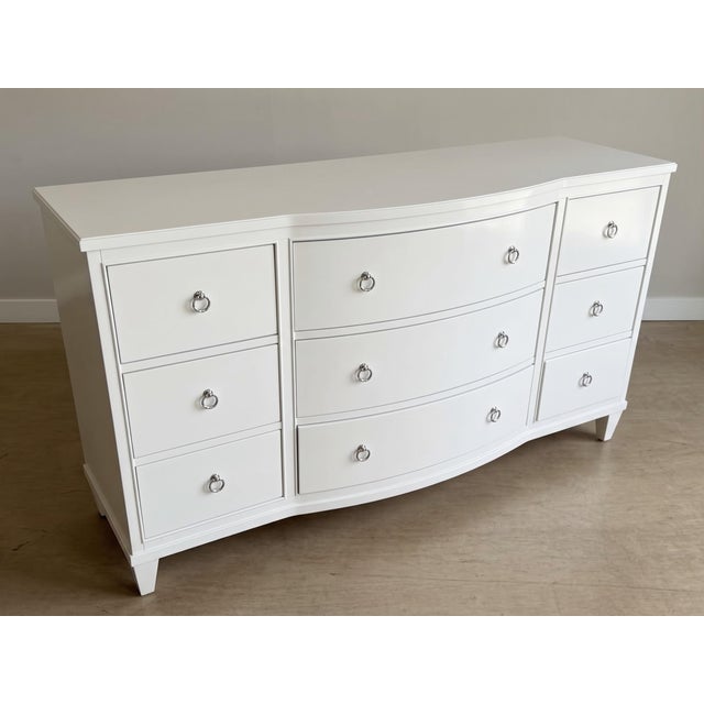 An elegant Ethan Allen Heston nine-drawer triple dresser in the original Ascot (793) white lacquer finish, featuring a...