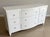 An elegant Ethan Allen Heston nine-drawer triple dresser in the original Ascot (793) white lacquer finish, featuring a...