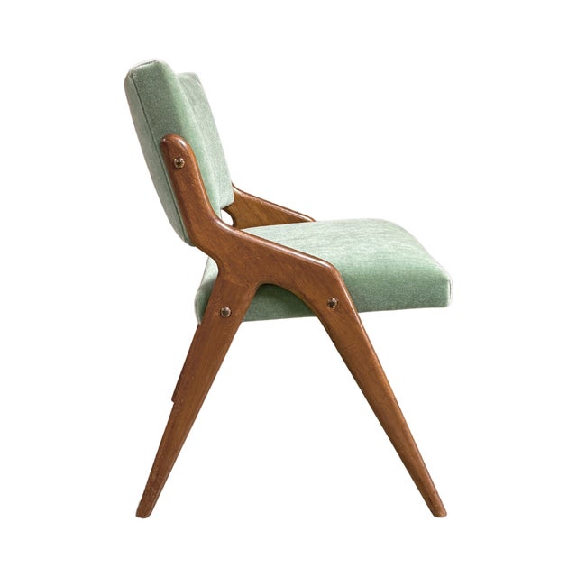 A rare set of four vintage 1950s mid-century modern dining chairs produced by Beresford & Hicks of London. The chairs...