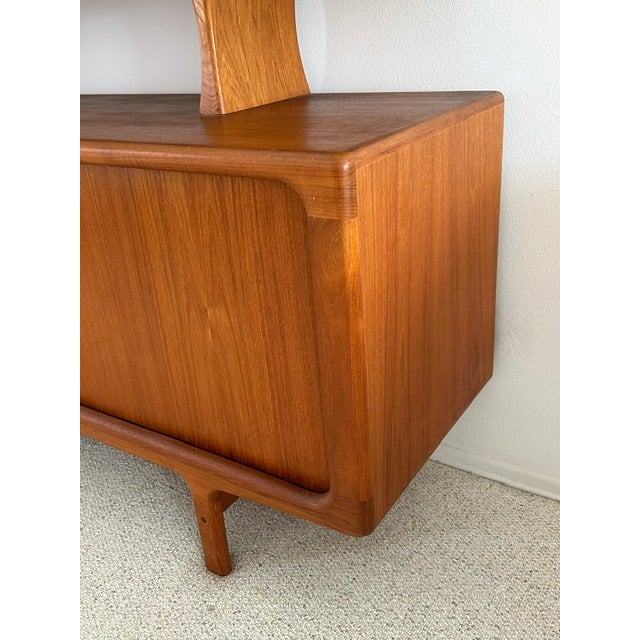 Classic Danish mid-century modern teak credenza with rounded corners and sliding doors; hutch with teak shelf and glass...