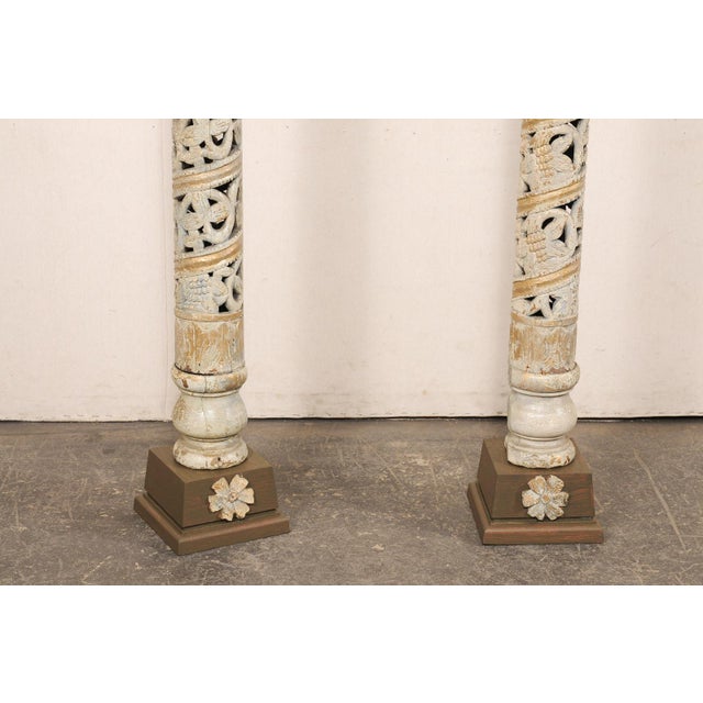 A tall pair of Italian pierce-carved and painted wood columns, from the turn of the 18th and 19th century. These antique...