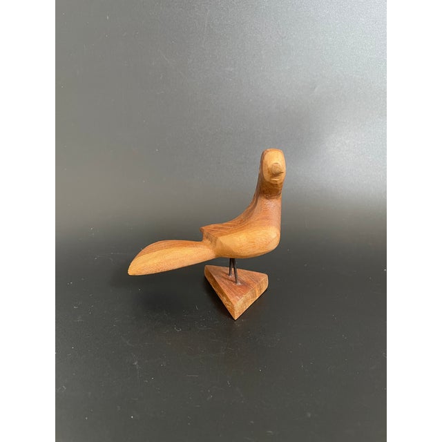 This Mid-Century Modern teak bird was hand crafted with Inlaid eyes, and was mounted to a triangular stand. Nice...