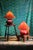 A pair of red glass painted table lamps in the Art Deco style. New clip on orange (or terracotta) colored shades in fabric...