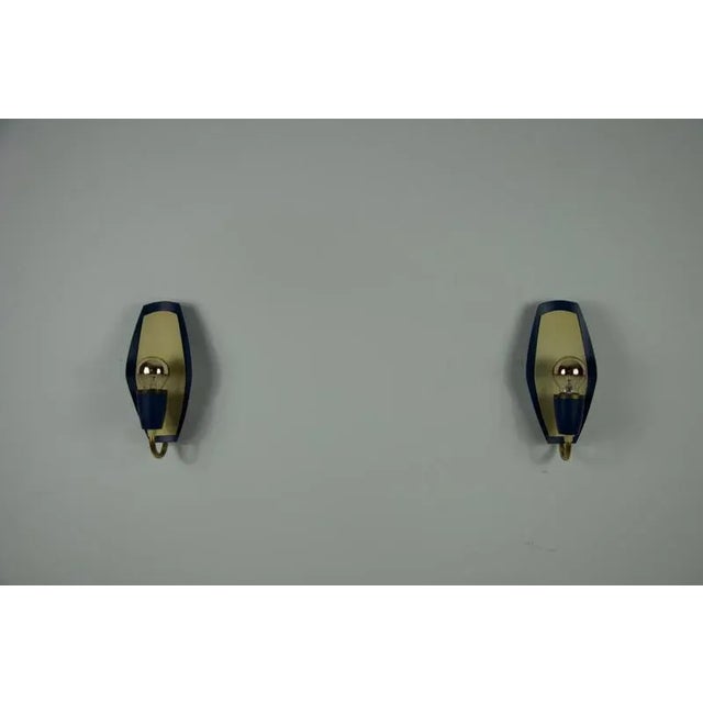 This stylish pair of wall lamps from 1960s germany captures the essence of mid-century modern design with their bold...