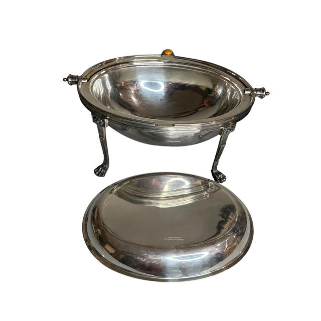 This refined vintage Carrington hotel silverplate chafing dish features a classic domed lid, elegant neoclassical legs,...