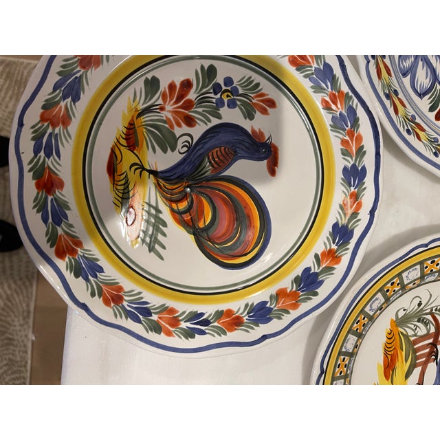 Beautiful Collection of 8 Henriot Quimper ceramic plates made in the 1990s. Each plate has a different border and...