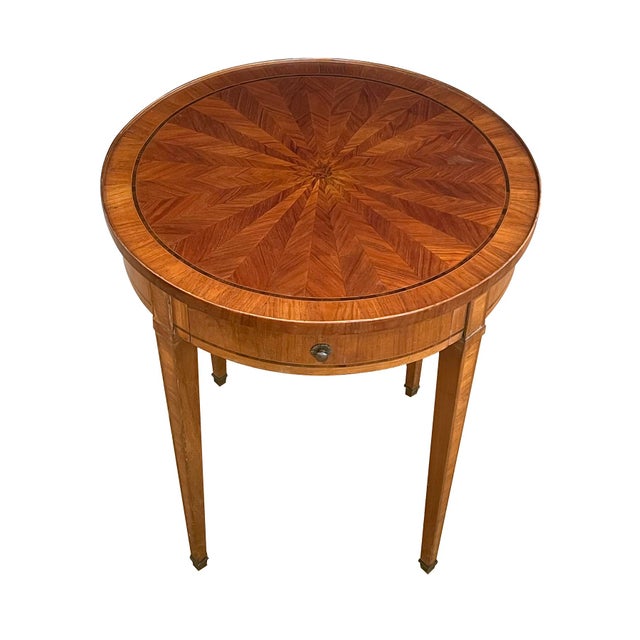 the circular top of radiating herringbone tulipwood marquetry within a kingwood perimeter band with cross-banded outer...