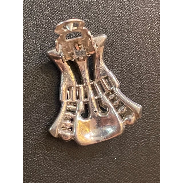 These patented clip mechanisms are one of the most iconic pieces of hardware in mid-century American costume jewelry...