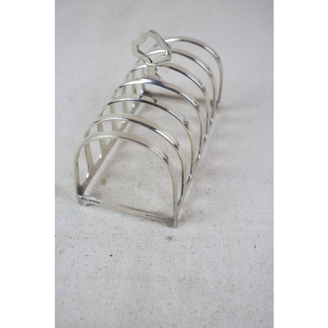 A mid 20th century English toast rack made of brass wiith a nickel finish.