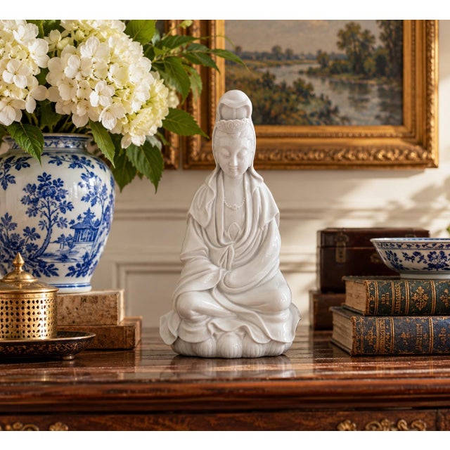 A serene mid-century blanc de chine porcelain figure depicting Guanyin, the bodhisattva traditionally associated with...